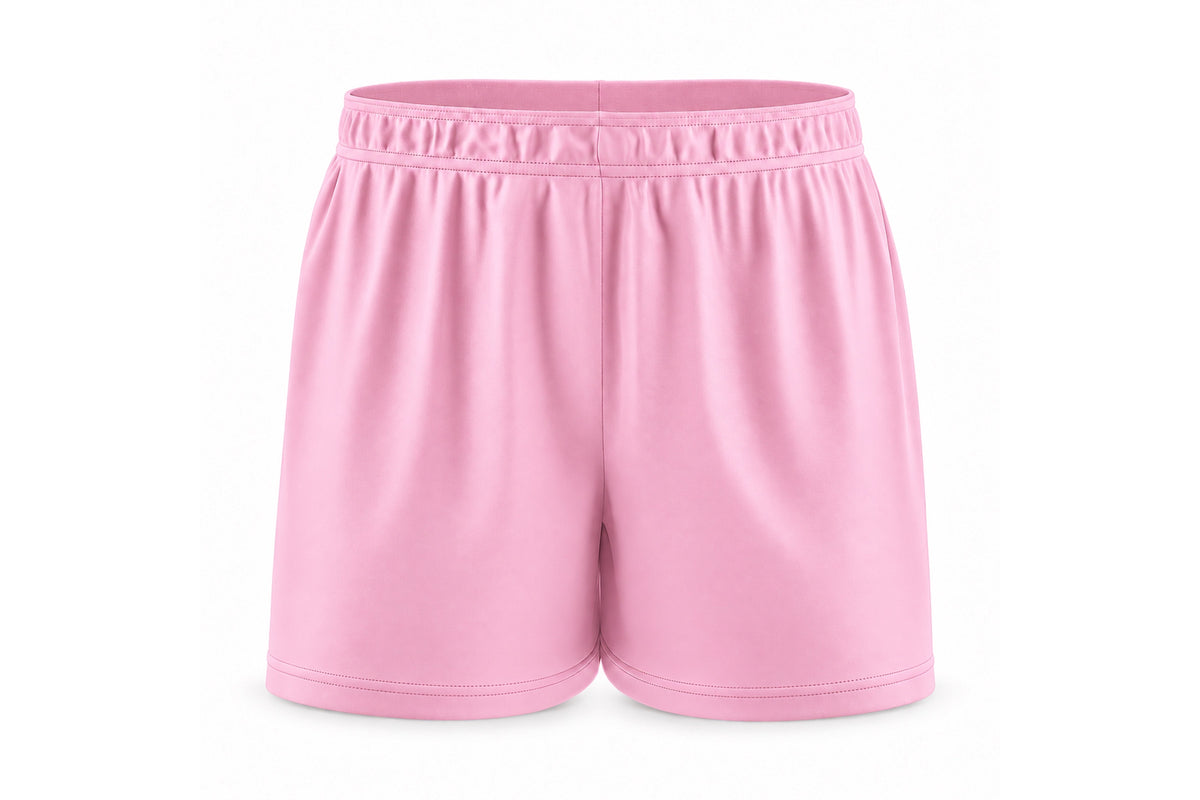 Front view of blank light pink custom sublimated athletic shorts with elastic waistband and stitched hems on a white background.