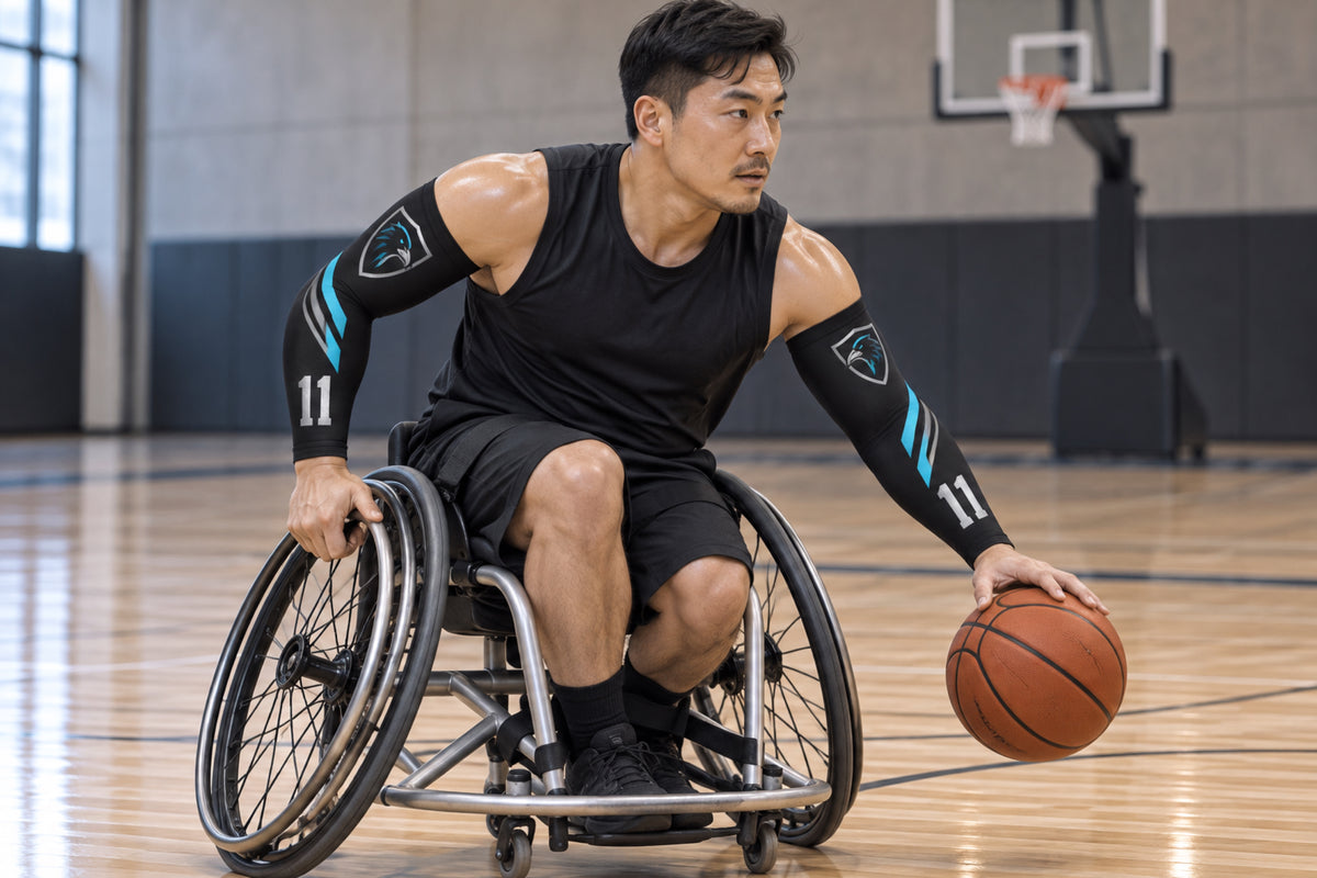 Wheelchair basketball player driving with the ball in Black custom arm sleeves with a raven crest and number 11