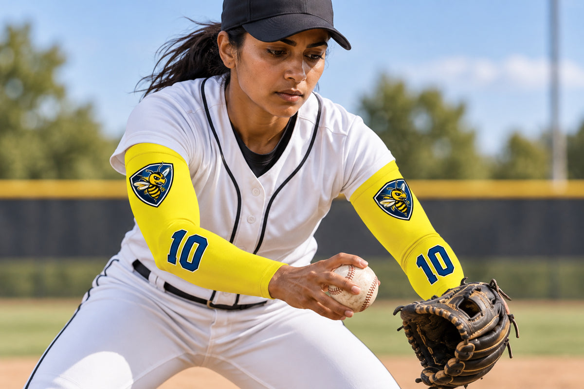 Shortstop moving the ball from glove to hand in Bright Yellow custom arm sleeves with a bee crest and number 10