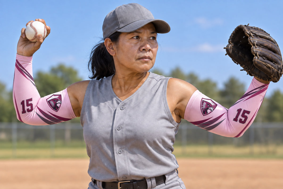 Pitcher beginning the delivery in Light Pink custom arm sleeves with a falcon crest and number 15