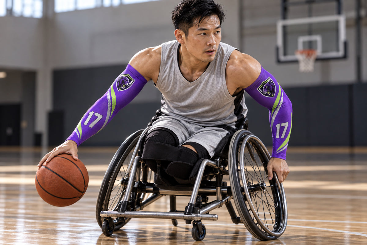 Wheelchair basketball player driving with the ball in Purple custom arm sleeves with a panther crest and number 17