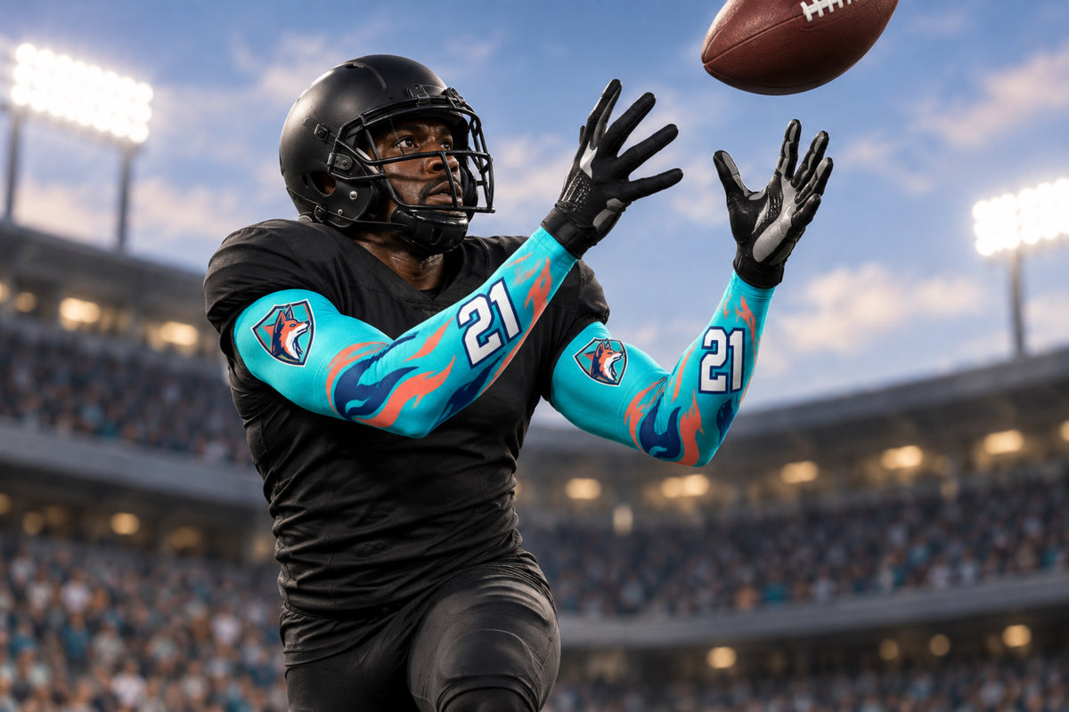 Football receiver tracking a pass over the shoulder in Turquoise custom arm sleeves with a coyote crest and number 21