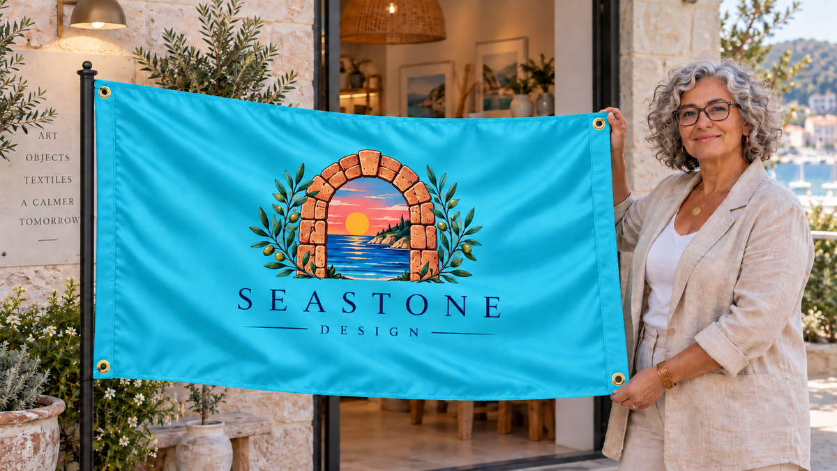 Illustrative campaign: business owner displaying a customized multicolor aqua blue 3 by 5 Seastone Design flag outside a coastal showroom