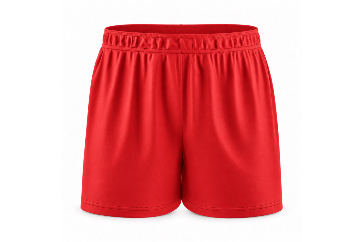 Front view of blank red custom sublimated athletic shorts with elastic waistband and stitched hems on a white background.