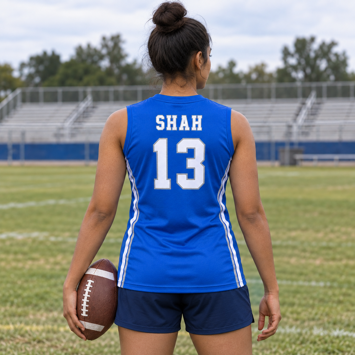 Royal Blue custom 7-on-7 football jersey on a woman, back campaign view with SHAH and number 13; AI-generated customization example