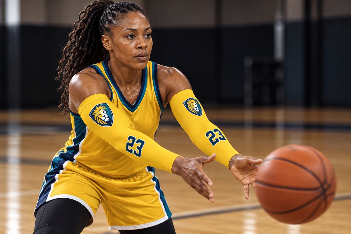 Basketball player making a bounce pass in Athletic Gold custom arm sleeves with a lion crest and number 23