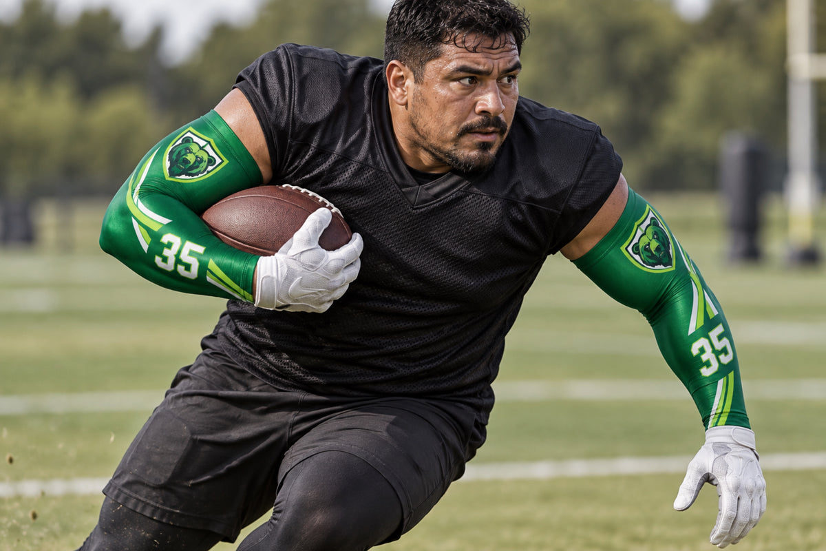 Running back carrying the football upfield in Forest Green custom arm sleeves with a bear crest and number 35