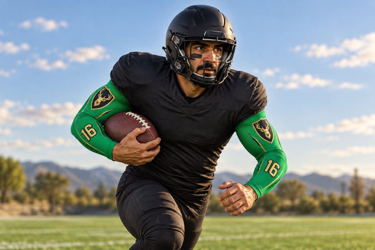 Running back accelerating with the ball tucked in Kelly Green custom arm sleeves with a stag crest and number 16