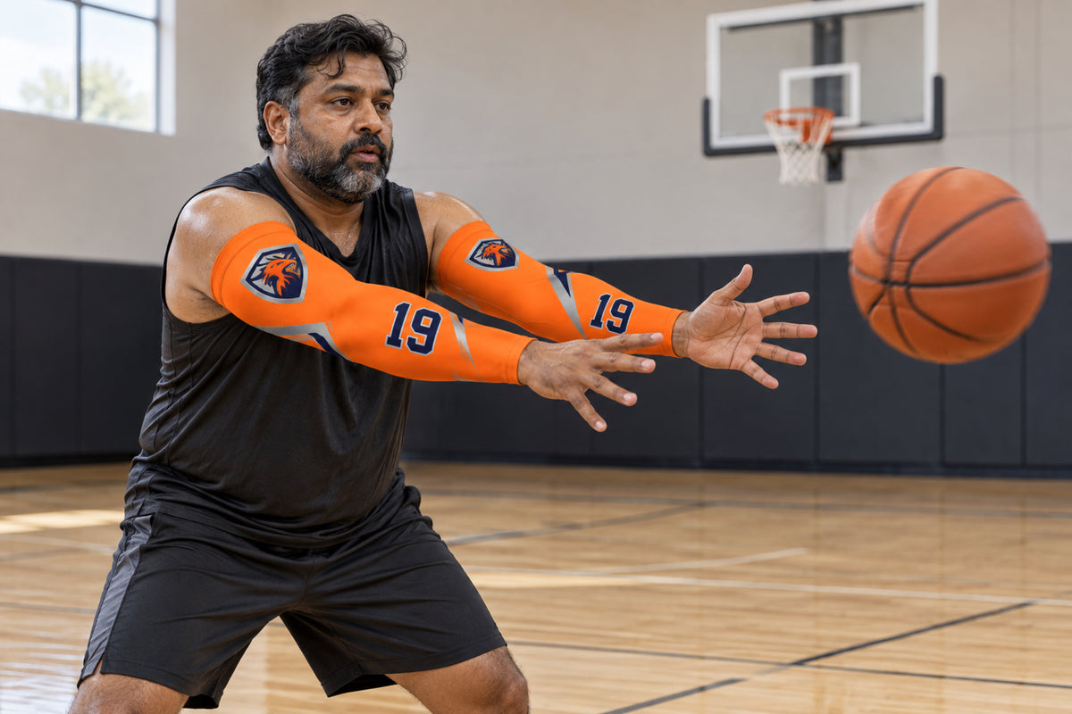 Basketball player making a chest pass in Orange custom arm sleeves with a firebird crest and number 19