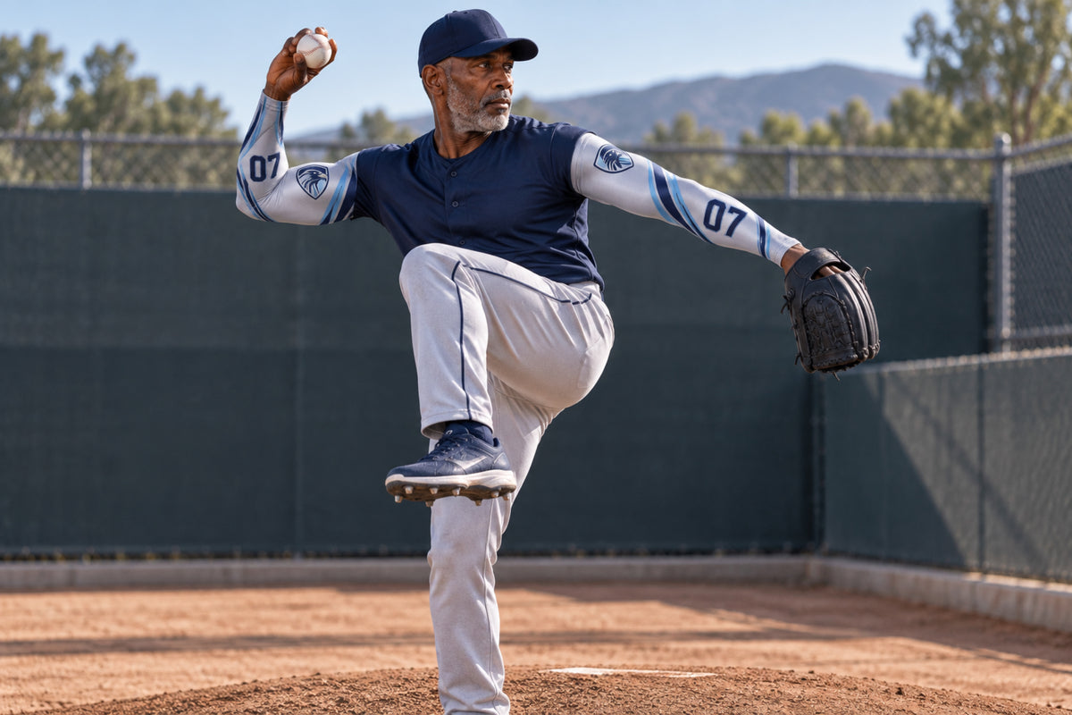 Baseball pitcher in a leg kick in Silver Gray custom arm sleeves with a falcon crest and number 07