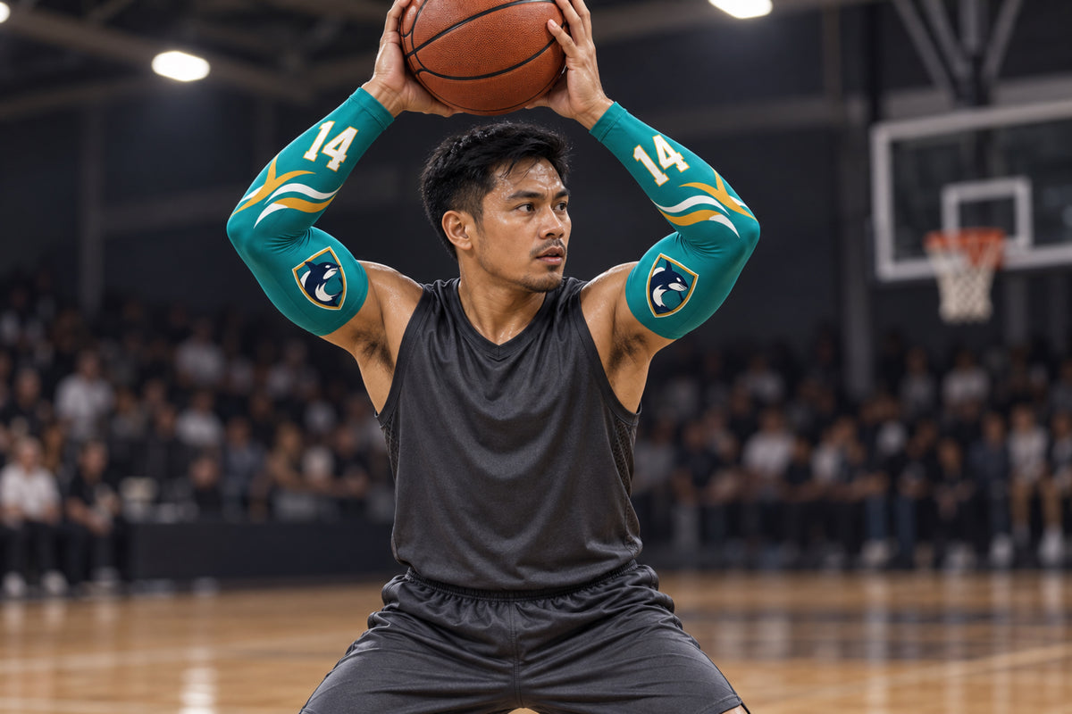Basketball player making an overhead pass in Teal custom arm sleeves with an orca crest and number 14